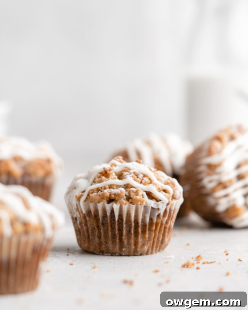 These moist banana muffins are topped with a buttery streusel topping and a simple creamy glaze!