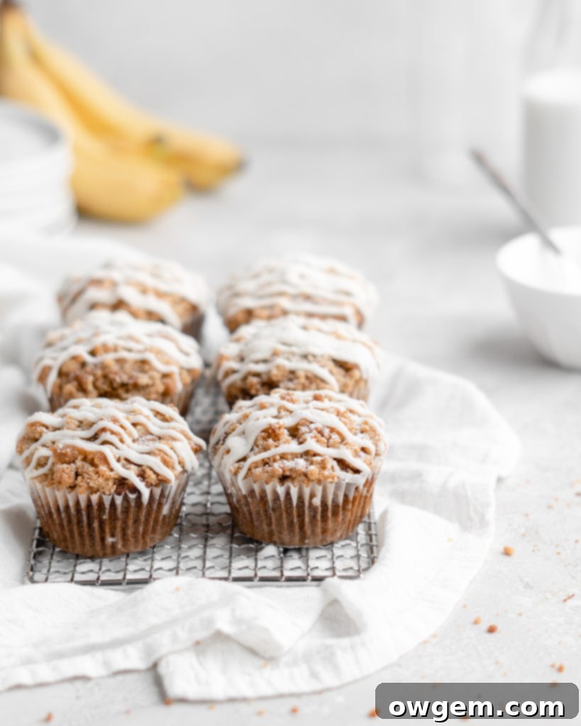 These moist banana muffins are topped with a buttery streusel topping and a simple creamy glaze!