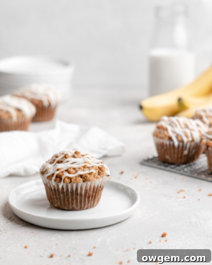 These moist banana muffins are topped with a buttery streusel topping and a simple creamy glaze!