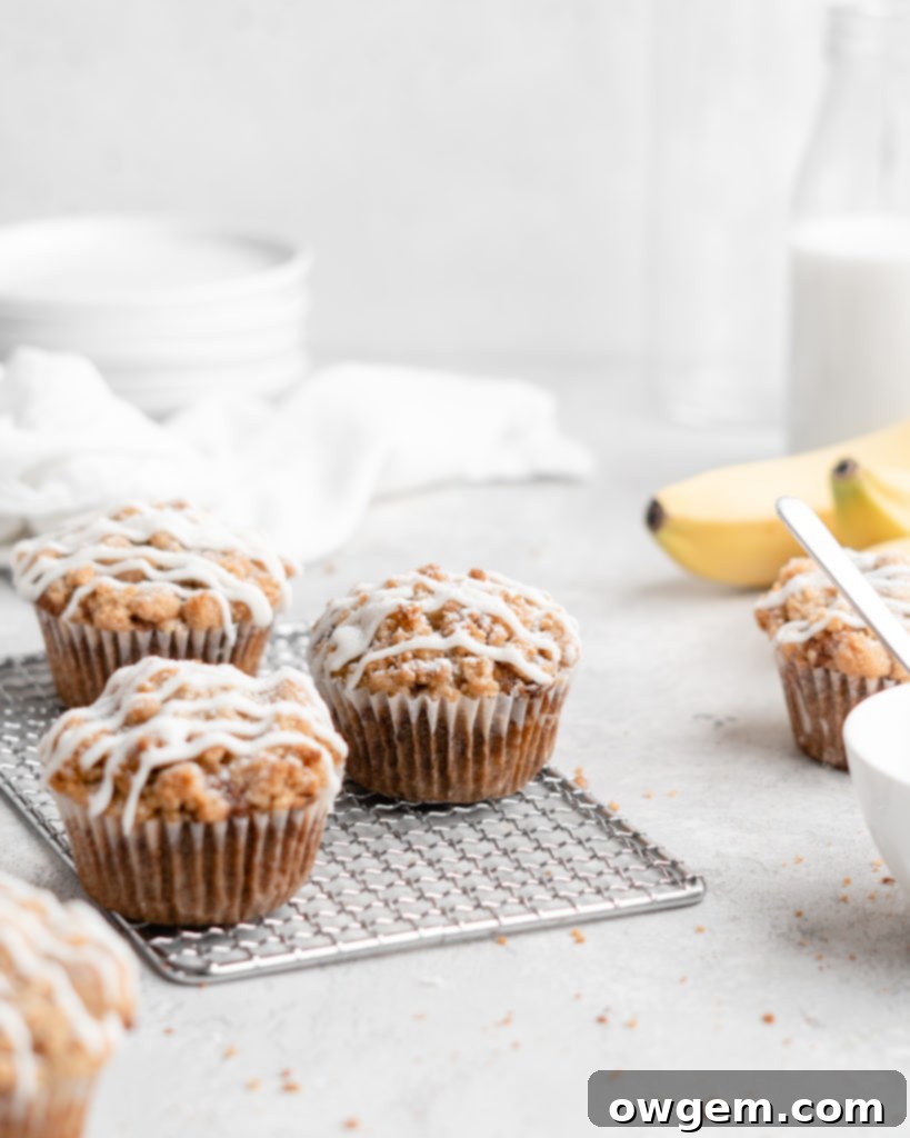 These moist banana muffins are topped with a buttery streusel topping and a simple creamy glaze!