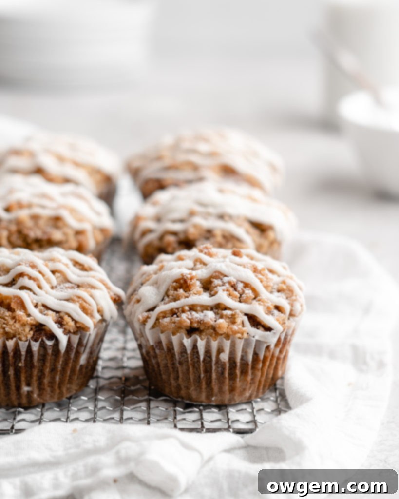 These moist banana muffins are topped with a buttery streusel topping and a simple creamy glaze!