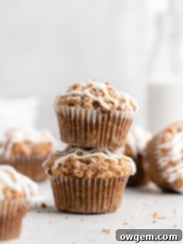 These moist banana muffins are topped with a buttery streusel topping and a simple creamy glaze!