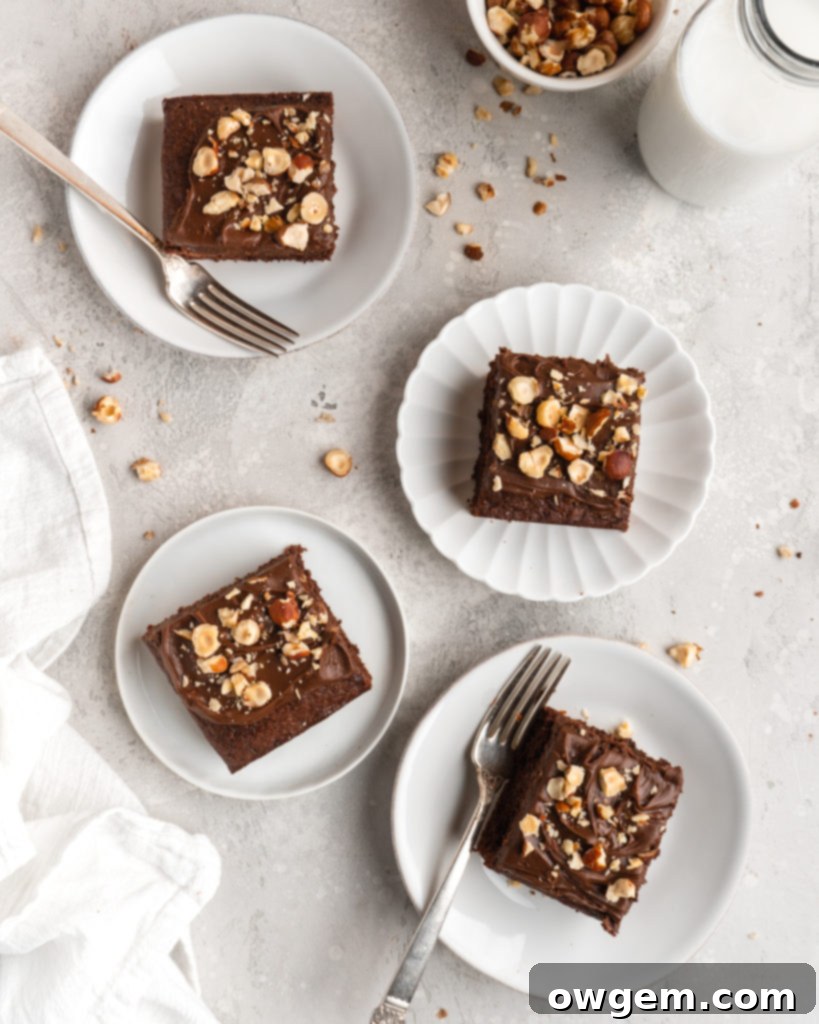 A close-up view of dark, rich bloomed Dutch processed cocoa powder mixed with hot coffee, ready to be added to the cake batter.
