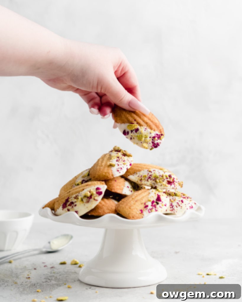 Close-up of baked Pistachio Rosewater Madeleines with their signature 'hump'.