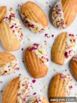 Pistachio madeleines made with rose water and dipped in white chocolate