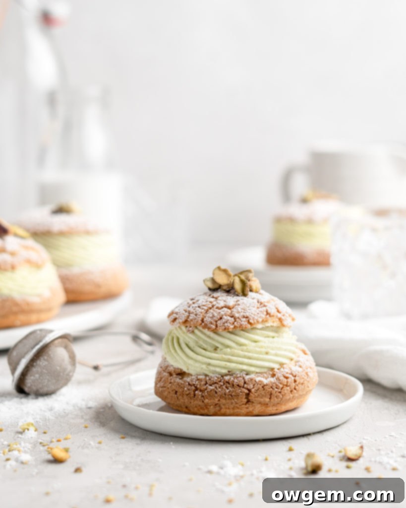Cream Puff with craquelin topping, filled with a thick piped layer of whipped pistachio white chocolate ganache
