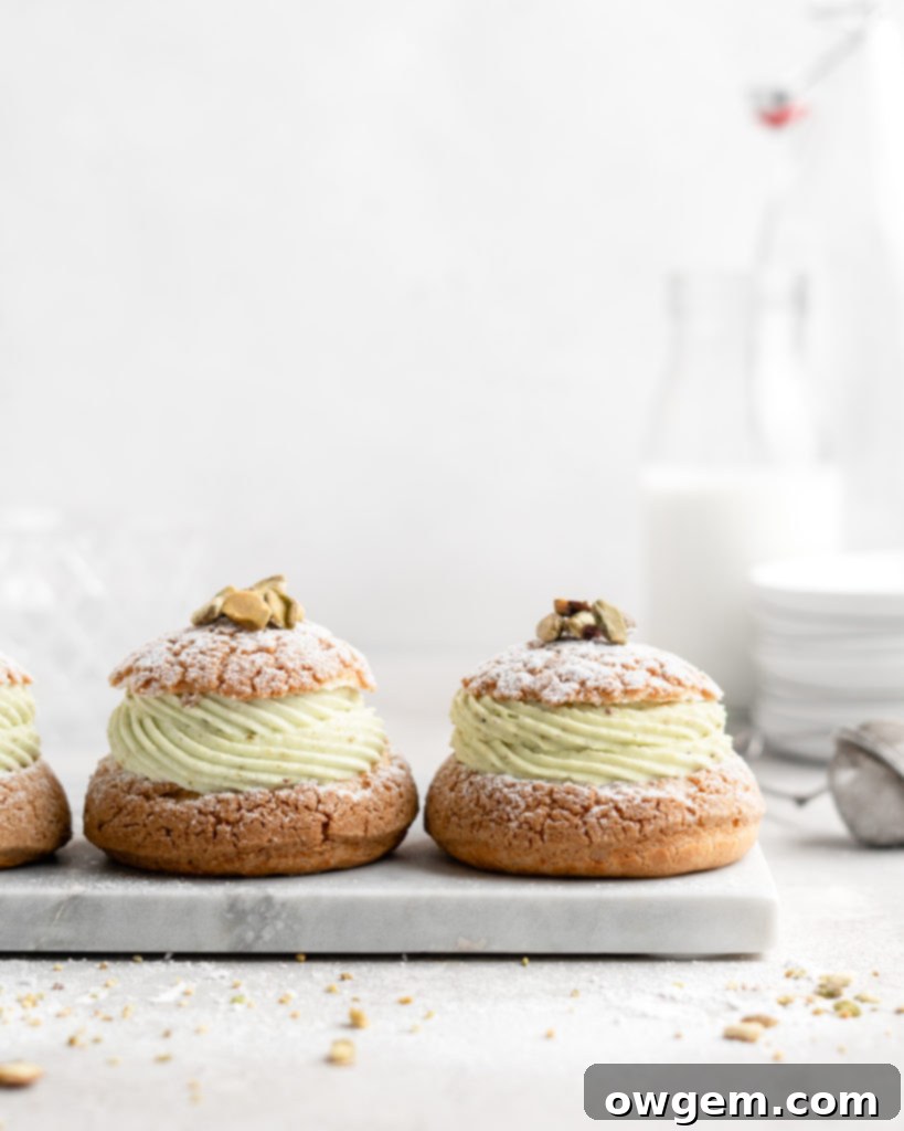 Cream Puff with craquelin topping, filled with a thick piped layer of whipped pistachio white chocolate ganache