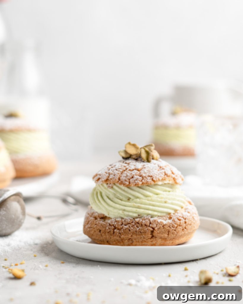 Cream Puff with craquelin topping, filled with a thick piped layer of whipped pistachio white chocolate ganache