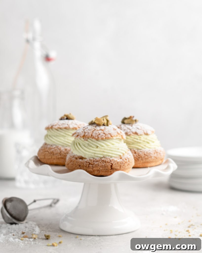 Cream Puff with craquelin topping, filled with a thick piped layer of whipped pistachio white chocolate ganache