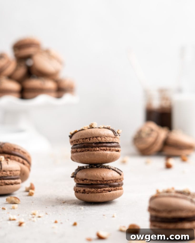 Chocolate macarons are filled with a delicious and easy to make Nutella Buttercream in these Nutella Macarons