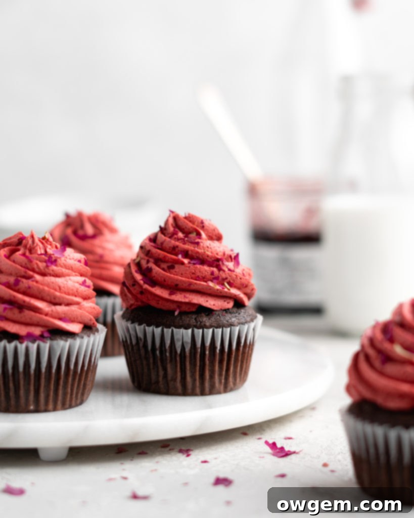 Close-up showing the process of filling a chocolate cupcake with cherry jam, demonstrating how easy it is