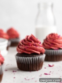 Fudgy chocolate cupcakes are filled with sweet cherry jam and topped with a cherry rosewater frosting