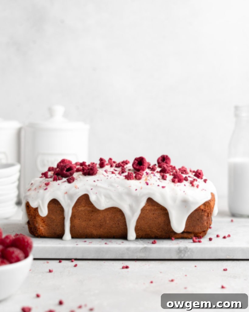 A close-up shot of the stunning pink hue of the Raspberry Rose Yogurt Loaf Cake glaze, highlighting its thick and luscious texture.