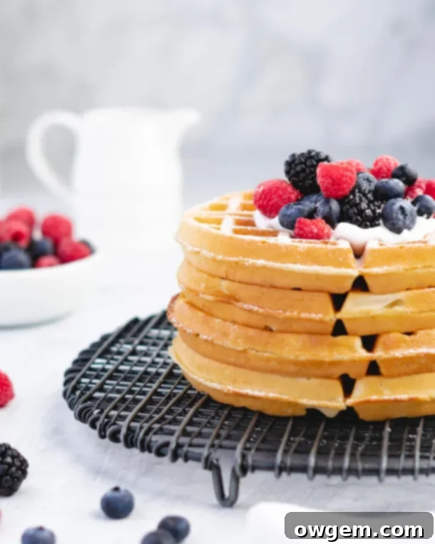 A perfectly cooked, golden Buttermilk Belgian Waffle with steam rising, indicating its freshness