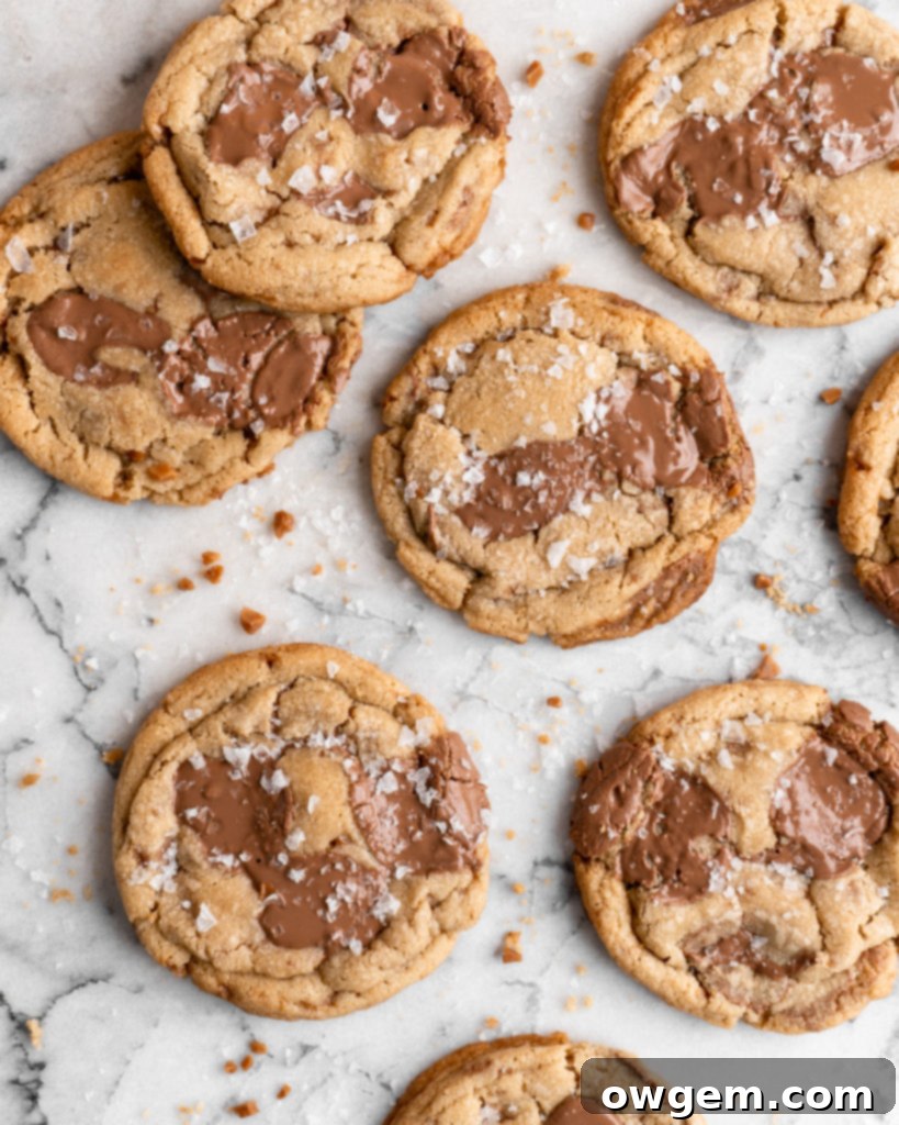 Chewy golden Toffee Milk Chocolate Chip Cookies on marble counter