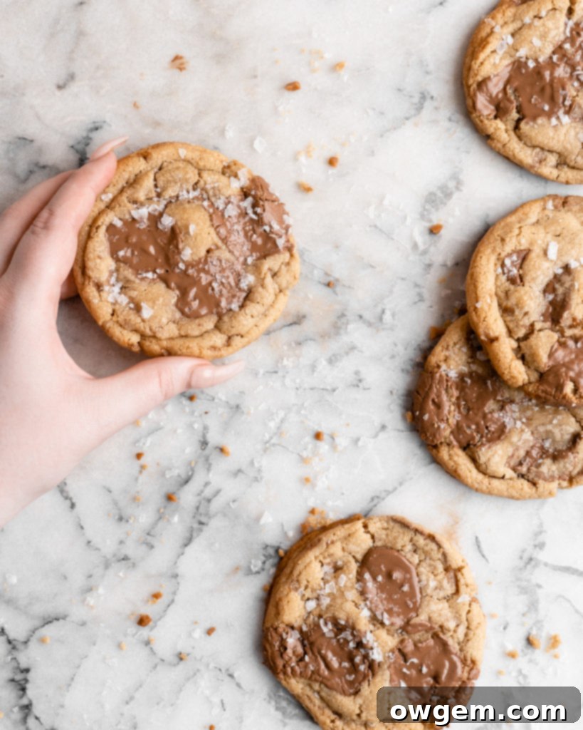Chewy golden Toffee Milk Chocolate Chip Cookies on marble counter