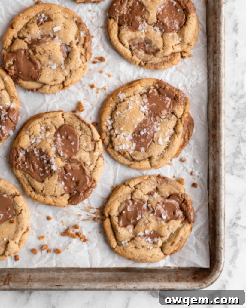 Chewy golden Toffee Milk Chocolate Chip Cookies on baking sheet
