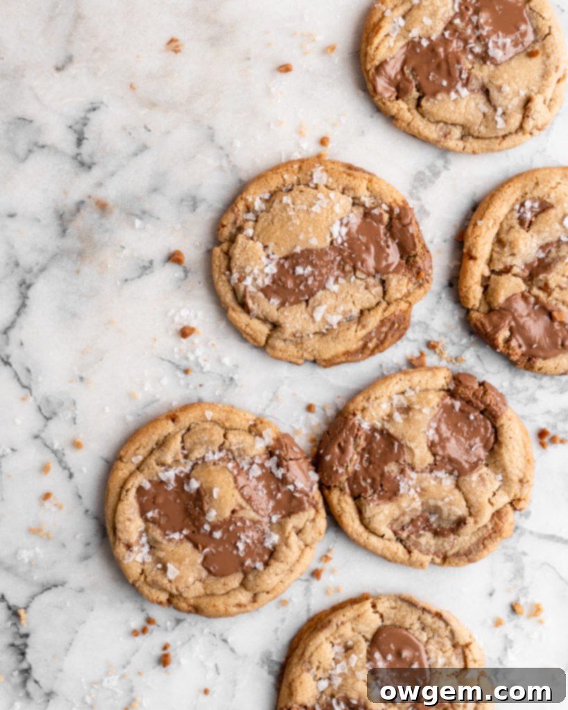 Chewy golden Toffee Milk Chocolate Chip Cookies on marble counter