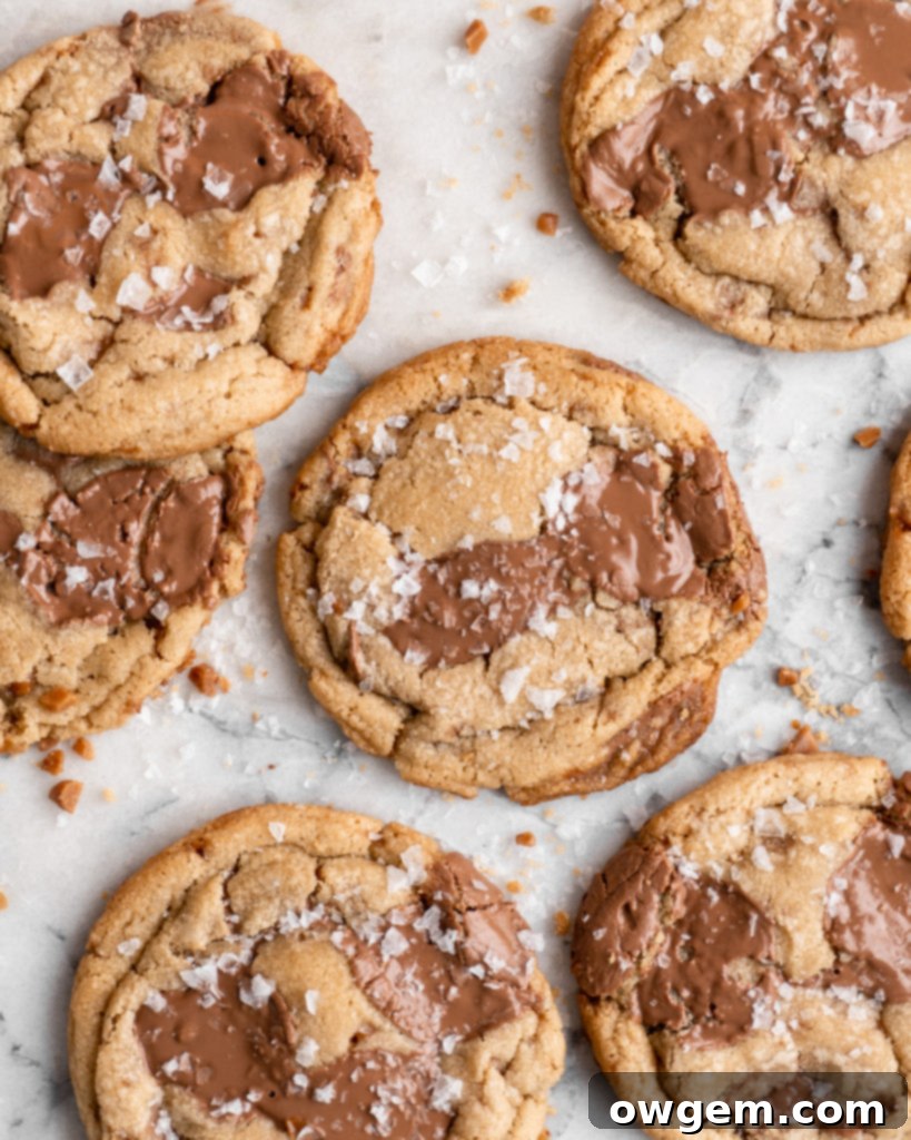 Chewy golden Toffee Milk Chocolate Chip Cookies on marble counter