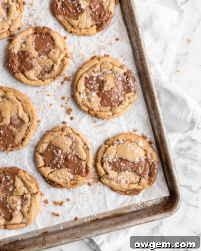 Chewy golden Toffee Milk Chocolate Chip Cookies on baking sheet