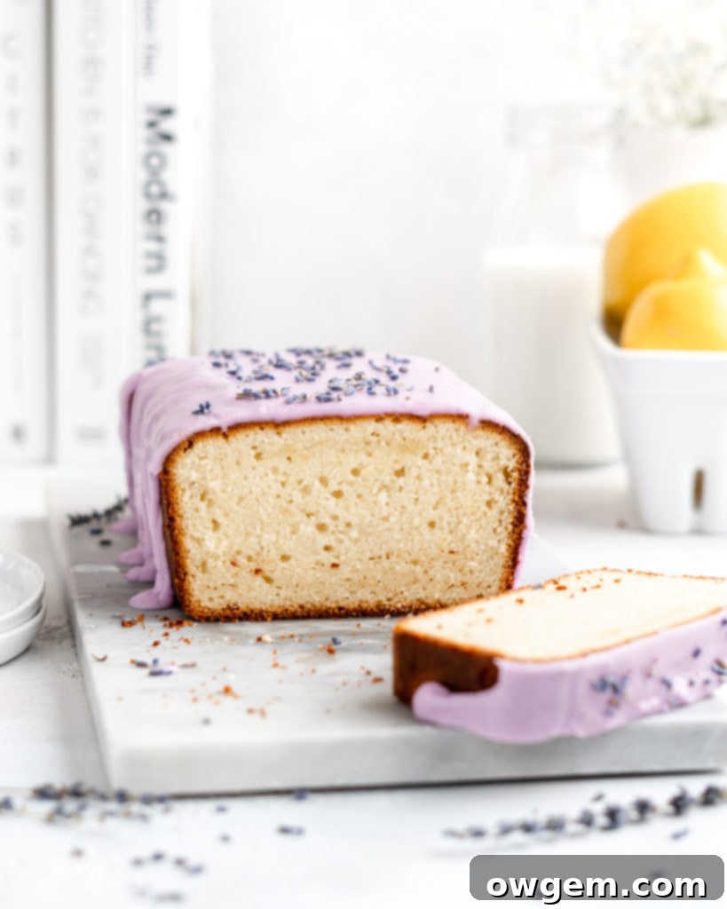 Detailed shot of purple vanilla glaze being drizzled over a Lemon and lavender loaf cake