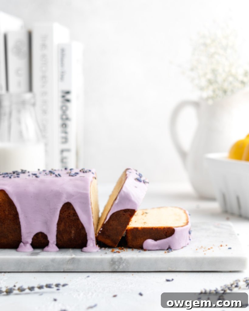 Two slices of moist Lemon and lavender loaf cake with purple vanilla glaze