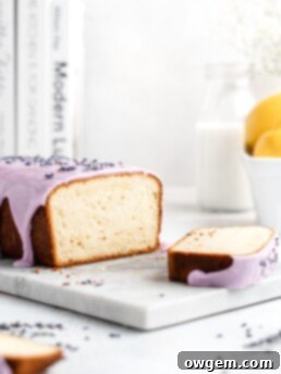Fluffy and moist Lemon and lavender loaf cake is glazed in a purple coloured vanilla glaze