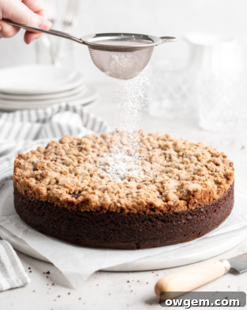 A close-up view of the golden-brown, crumbly toffee streusel topping on a baked chocolate cake.