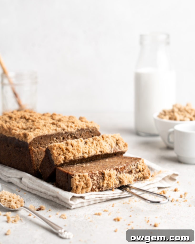 Moist, tender, and richly flavored Chai Spiced Banana Bread loaf with a golden streusel topping, sliced to show its perfect texture.