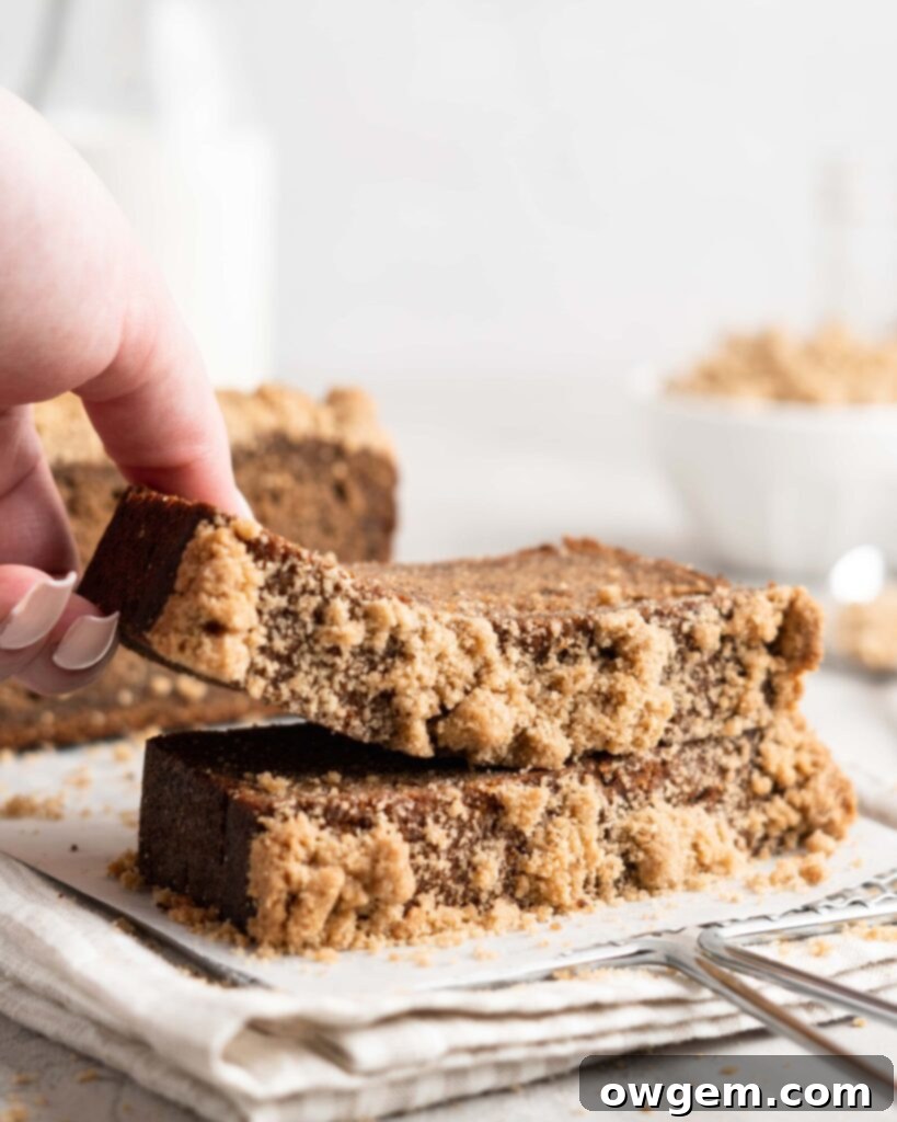 Two freshly baked Chai Spiced Banana Bread loaves, one whole and one sliced, presented beautifully.