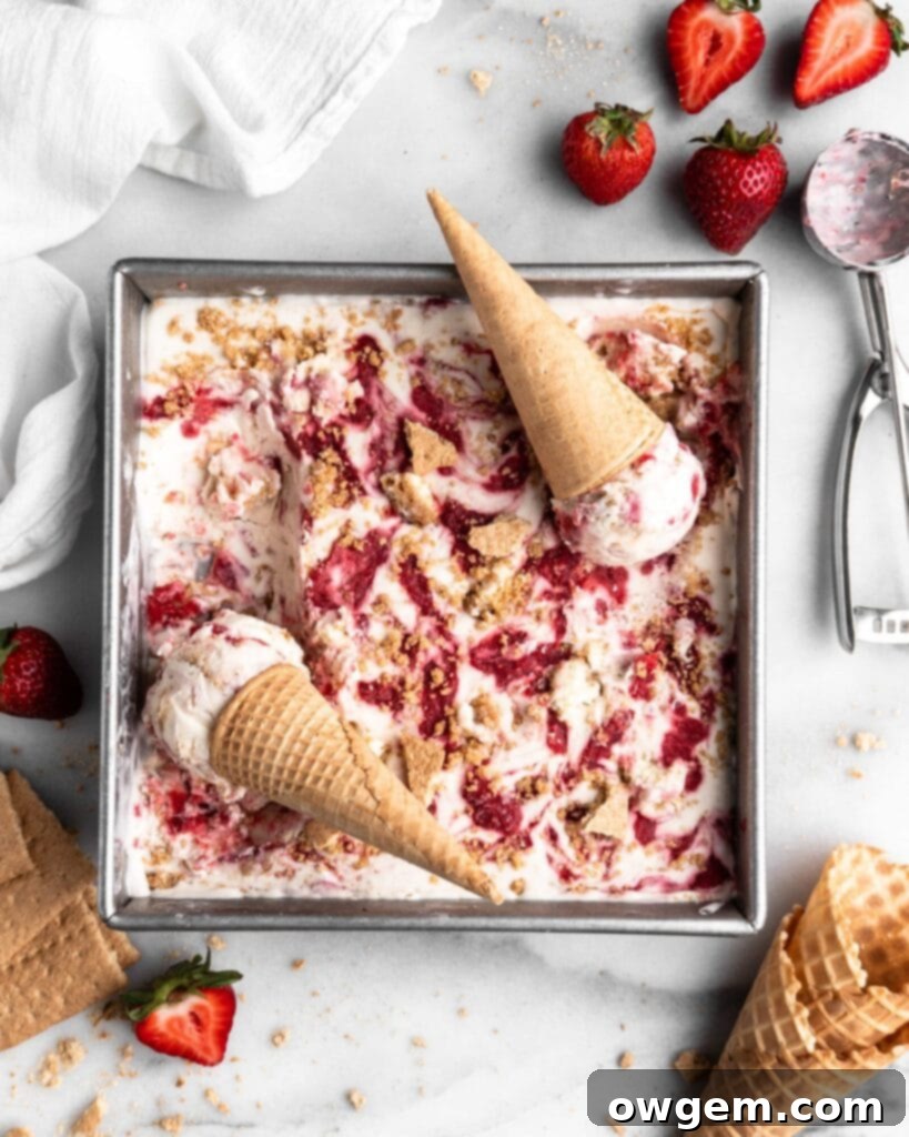 No Churn Strawberry Cheesecake Ice Cream in a square pan with cones