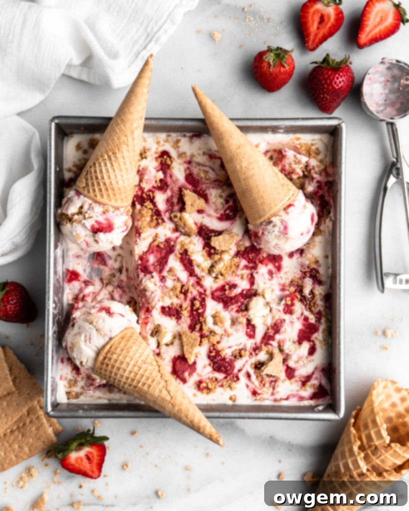 No Churn Strawberry Cheesecake Ice Cream in a square pan with cones