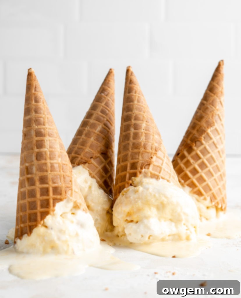 Scoops of homemade salted honey and peach no-churn ice cream in waffle cones
