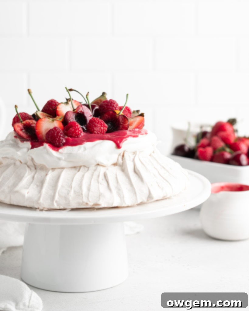 A close-up of a Summer Berry Pavlova, featuring the crisp meringue shell and the soft, fluffy interior.