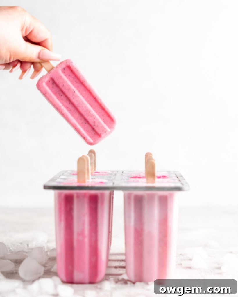 Bright pink popsicles are made with guava juice, dragon fruit (pitaya), greek yogurt, and agave.