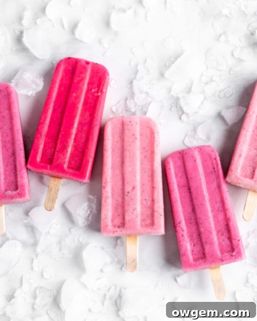 Bright pink popsicles are made with guava juice, dragon fruit (pitaya), greek yogurt, and agave.