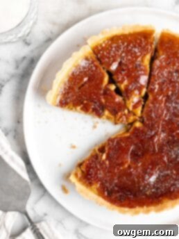 Velvety pumpkin tart is topped with a creme brulee topping and baked in a buttery shortbread crust