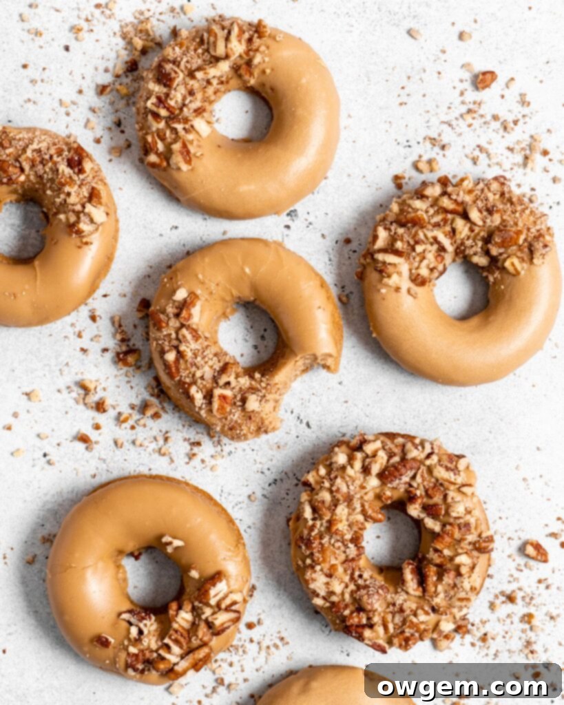 Beautifully glazed Baked Spiced Brown Sugar Donuts adorned with a crushed pecan crust, perfect for fall