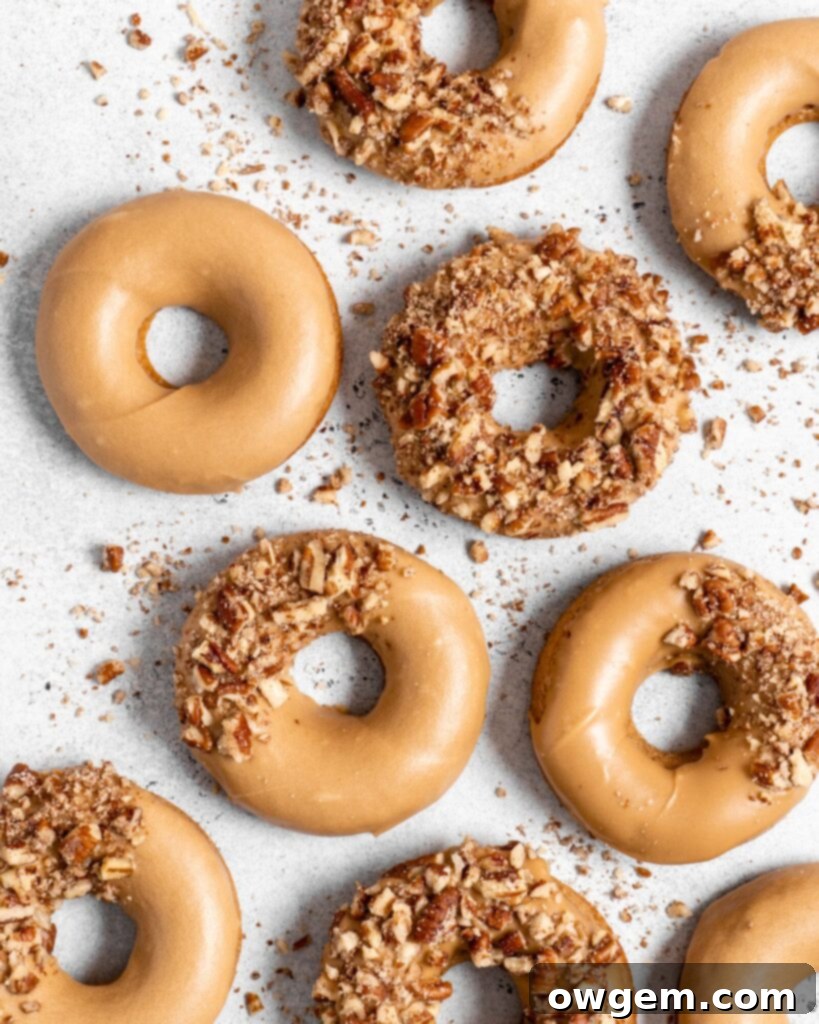 Close-up of Baked Spiced Brown Sugar Donuts with maple glaze and crushed pecans