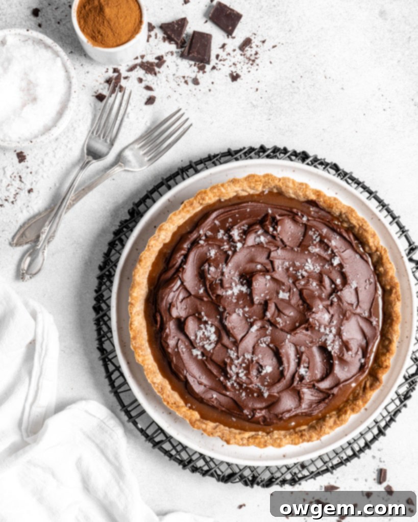 This Chai Salted Caramel Chocolate Tart features a spicy chai infused crust, chai salted caramel filling, and a creamy chocolate ganache topping