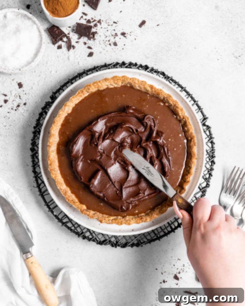 This Chai Salted Caramel Chocolate Tart features a spicy chai infused crust, chai salted caramel filling, and a creamy chocolate ganache topping