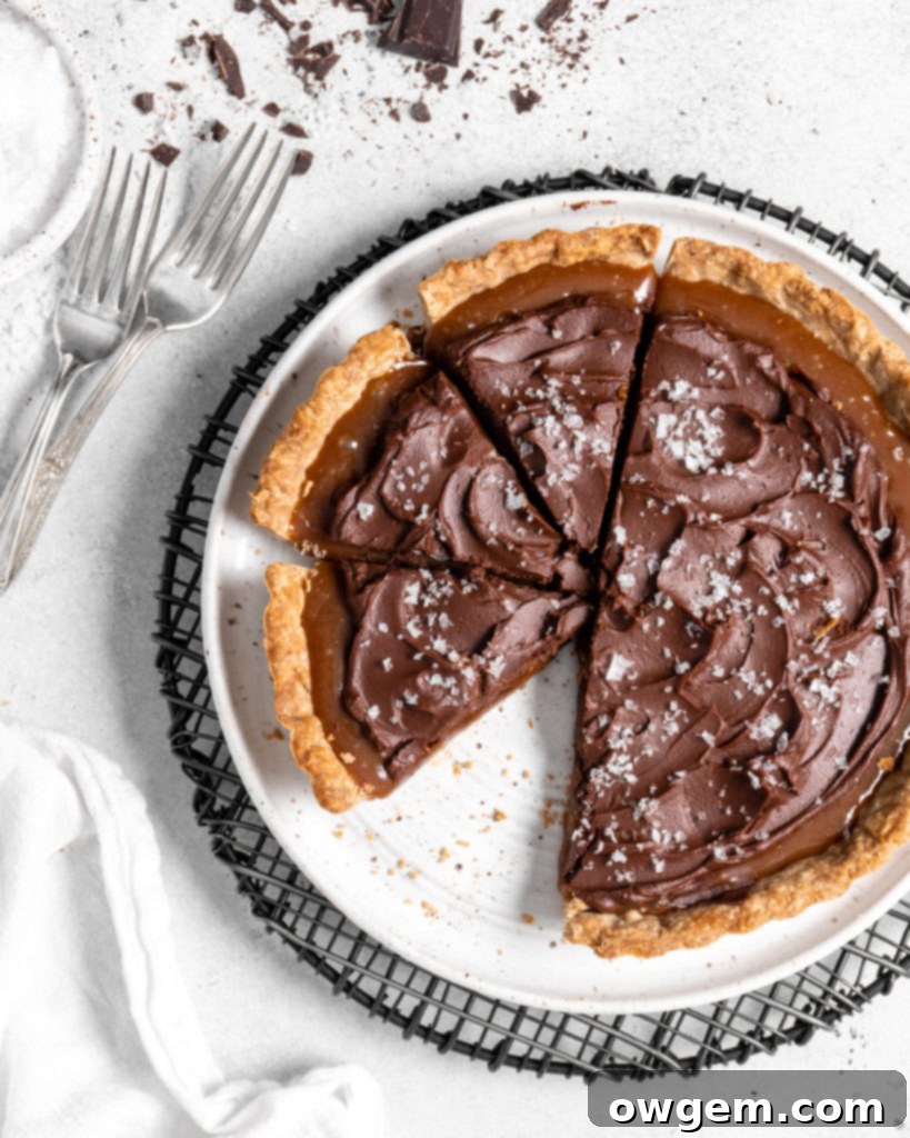 This Chai Salted Caramel Chocolate Tart features a spicy chai infused crust, chai salted caramel filling, and a creamy chocolate ganache topping