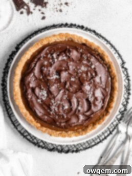 This Chai Salted Caramel Chocolate Tart features a spicy chai infused crust, chai salted caramel filling, and a creamy chocolate ganache topping