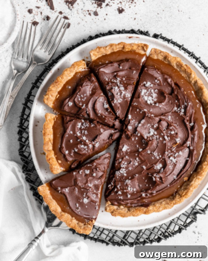 This Chai Salted Caramel Chocolate Tart features a spicy chai infused crust, chai salted caramel filling, and a creamy chocolate ganache topping