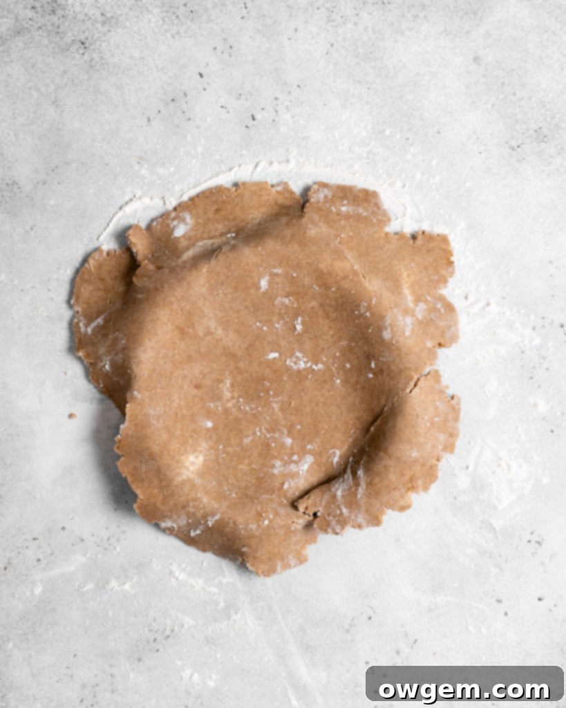 Pricking the bottom of the tart crust with a fork before blind baking.