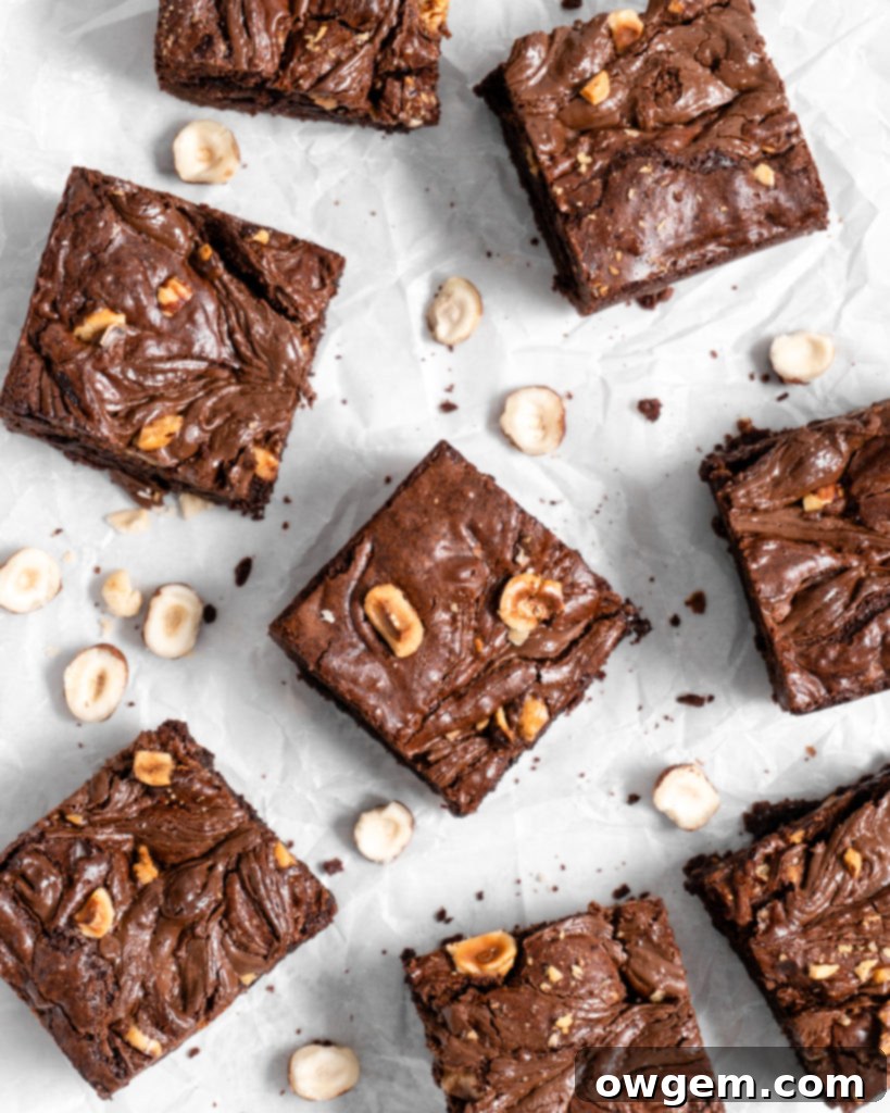 Toasted whole hazelnuts and hazelnut flour on baking sheets, golden brown and fragrant, for Nutella brownies
