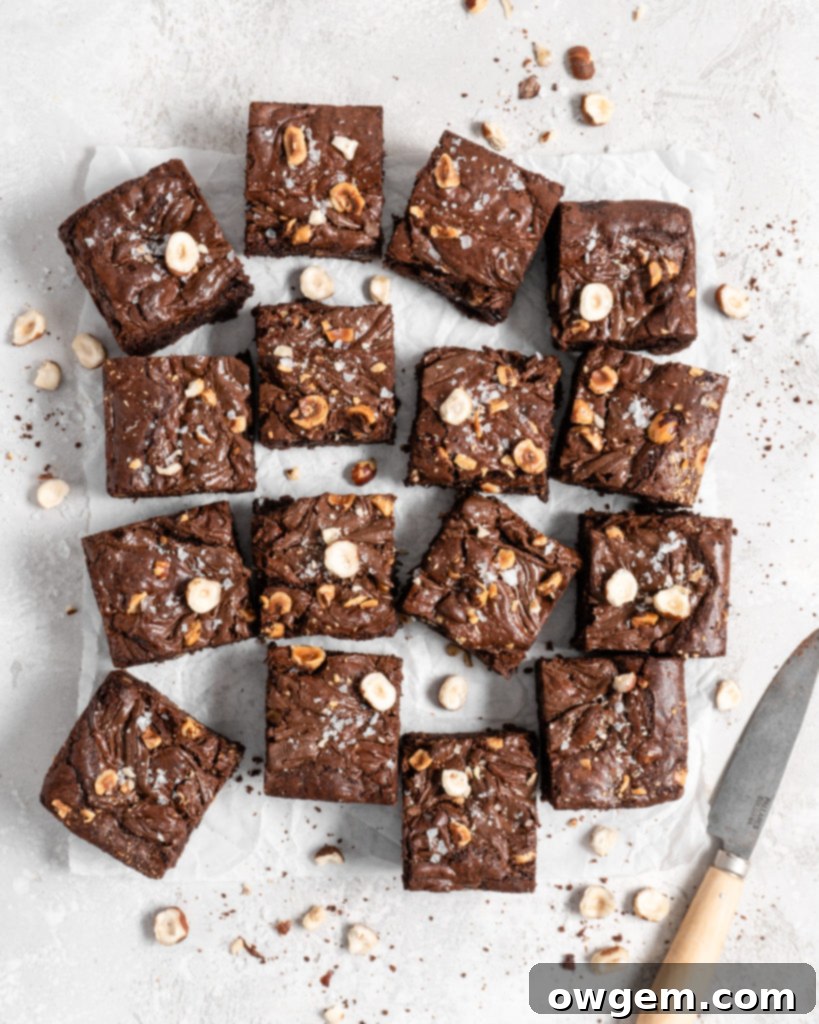 A square of fudgy toasted hazelnut Nutella brownie on a cooling rack, showing off its rich, dense texture and chocolatey goodness