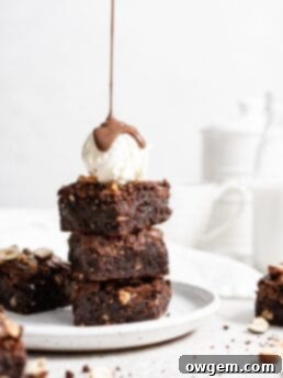 Fudgy toasted hazelnut brownies swirled with Nutella, ready to be sliced and served