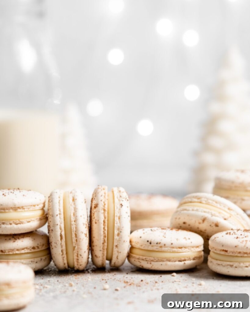 Festive eggnog macarons filled with creamy eggnog white chocolate ganache, arranged on a beautiful Christmas table setting.
