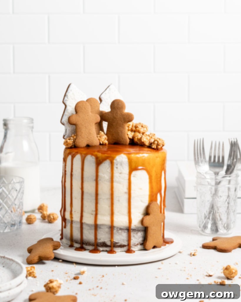 Beautifully decorated naked style gingerbread layer cake with swirls of cream cheese frosting and a rich salted caramel drip, ready for a festive gathering